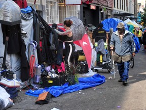 What the tragic death of a Mountie trying to help says about the homelessness crisis - alberta government announcements People pack up as officials enforce an order to clear tents occupied by homeless people from the sidewalks in Vancouver’s Downtown Eastside on August 9, 2022.