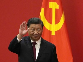 FILE - Chinese President Xi Jinping waves at an event to introduce new members of the Politburo Standing Committee at the Great Hall of the People in Beijing on Oct. 23, 2022. China on Friday, Nov. 11, confirmed President Xi Jinping will attend both the meeting of the Group of 20 industrialized countries and the gathering of Asian Pacific nations this month in his first major overseas trip since the beginning of the COVID-19 pandemic.