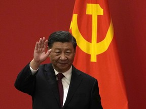 FILE - Chinese President Xi Jinping waves at an event to introduce new members of the Politburo Standing Committee at the Great Hall of the People in Beijing on Oct. 23, 2022. Barely a month after granting himself new powers as China's possible leader for life, Xi is facing a wave of public anger of the kind not seen for decades, sparked by his draconian "zero-COVID" program that will soon enter its fourth year.