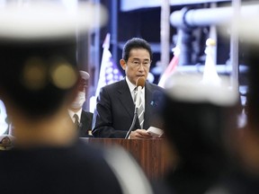 FILE - Japanese Prime Minister Fumio Kishida delivers a speech on the Maritime Self Defense Force's helicopter carrier JS Izumo during an international fleet review in Sagami Bay, southwest of Tokyo on Nov. 6, 2022. Japan and the United States began a major joint military exercise Thursday, Nov. 10, 2022 in southern Japan as the allies aim to step up readiness in the face of China's increasing assertiveness and North Korea's intensifying missile launches. (Kyodo News via AP, File)
