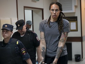WNBA star and two-time Olympic gold medalist Brittney Griner is escorted from a courtroom after a hearing in Khimki just outside Moscow, Russia, on Aug. 4, 2022. The jailed American basketball star has been moved to a penal colony in Russia, her legal team said Wednesday, Nov. 9, 2022.