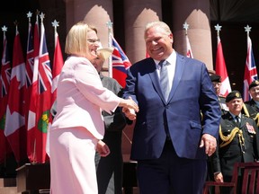 Sylvia Jones, Deputy Premier and Minister of Health shakes hands with Premier Doug Ford as she takes her oath at the swearing-in ceremony at Queen's Park in Toronto on June 24, 2022.Lawyers for Ford and Jones are set to argue in court today in an effort to get the pair out of testifying at the Emergencies Act inquiry.THE CANADIAN PRESS/Nathan Denette
