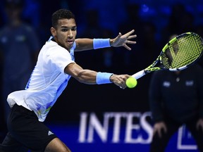 Felix Auger-Aliassime returns the ball to Rafael Nadal during their singles tennis match of the ATP World Tour Finals, at the Pala Alpitour in Turin, Italy, Tuesday, Nov. 15, 2022.