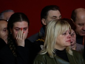 Colleagues and friends react during a funeral ceremony for Ukrainian serviceman and ballet dancer Vadym Khlupianets at the National Academic Operetta's Theatre in Kyiv.