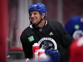 Former Vancouver Canucks defenceman Kevin Bieksa, who signed a one-day contract with the NHL hockey team to officially retire, takes a break as he skates with the team at the start of practice, in Vancouver, B.C., Thursday, Nov. 3, 2022. Bieksa will be honoured by the team with a retirement celebration prior to their game against the Anaheim Ducks on Thursday night.