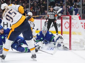 Nashville Predators' Matt Duchene (95) has his shot blocked by Vancouver Canucks' Ethan Bear (74) in front of goalie Thatcher Demko (35) during the first period of an NHL hockey game in Vancouver, on Saturday, November 5, 2022.