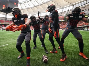 B.C. Lions' Keon Hatcher, from left to right, Alexander Hollins, Andrew Peirson, Dominique Rhymes and Jevon Cottoy celebrate Hatcher's touchdown against the Calgary Stampeders during the second half of the CFL western semifinal football game, in Vancouver, B.C., Sunday, Nov. 6, 2022.