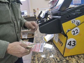 Bruce Gideos, floor manager at Pierre's Place, in Chesterfield, N.H., prints out Powerball tickets on Thursday, Nov. 3, 2022. The Powerball jackpot climbed over $1.5 billion on Thursday after no one won Wednesday's drawing.
