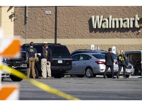 Law enforcement, including the FBI, work at the scene of a mass shooting at Walmart, Wednesday, Nov. 23, 2022, in Chesapeake, Va.