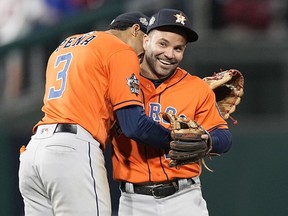 Houston Astros second baseman Jose Altuve and shortstop Jeremy Pena celebrate their win in Game 5 of baseball's World Series between the Houston Astros and the Philadelphia Phillies on Friday, Nov. 4, 2022, in Philadelphia. The Astros won 3-2, to take a one game lead in the best of seven series.