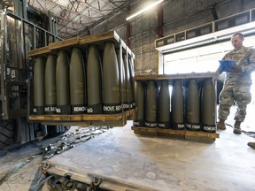 FILE - U.S. Air Force Staff Sgt. Cody Brown, right, with the 436th Aerial Port Squadron, checks pallets of 155 mm shells ultimately bound for Ukraine, April 29, 2022, at Dover Air Force Base, Del. Officials say the U.S. will send $400 million more in military aid to Ukraine amid concerns financial assistance for the war against Russia could decline if Republicans take control of Congress.