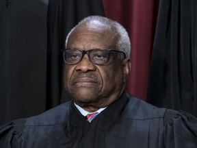 FILE - Associate Justice Clarence Thomas joins other members of the Supreme Court as they pose for a new group portrait, at the Supreme Court building in Washington, Oct. 7, 2022. Lawyers who aided former President Donald Trump's efforts to overturn the results of the 2020 election regarded an appeal to Thomas as a "key" to their success.