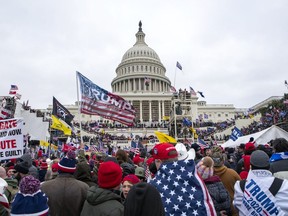FILE - Rioters loyal to President Donald Trump rally at the U.S. Capitol in Washington on Jan. 6, 2021. Samuel Christopher Montoya, a Texas man described as a video editor for the conspiracy theory-promoting Infowars website, pleaded guilty on Monday, Nov. 7, 2022, to storming the U.S. Capitol, where he captured footage of the scene where a police officer fatally shot a California woman who joined the mob's attack.