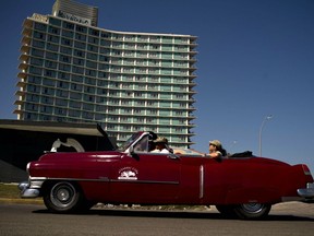 FILE - A vintage American car carries tourists next to hotel Riviera, managed by the Spanish company Iberostar, in Havana, Cuba, April 24, 2019. U.S. and Cuban officials plan to meet in Havana on Tuesday, Nov. 15, 2022, to discuss migration policy, the latest in a series of sessions between two governments with a historically icy relationship and amid one of the biggest migratory flights from the island in decades.
