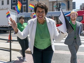 FILE - District of Columbia Mayor Muriel Bowser, center, arrives for a news conference ahead of DC Pride events, June 10, 2022, in Washington. At right is Japer Bowles, director of the Mayor's Office of Lesbian, Gay, Bisexual, Transgender and Questioning Affairs.