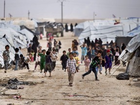 FILE - Children gather outside their tents at the al-Hol camp, which houses families of members of the Islamic State group, in Hasakeh province, Syria, May 1, 2021. Doctors Without Border warned in a report released Monday, Nov. 7, 2022, that the camp is witnessing pervasive violence, exploitation and lawless at a time when countries that have citizens in the facility have failed to take responsibility for protecting them.
