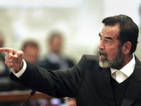 FILE - Former Iraqi president Saddam Hussein gestures during his trial in Baghdad, Iraq, Jan. 29, 2006. Lawyer Bushra al-Khalil said Sunday, Nov. 13, 2022 that her client Abdullah Yasser Sabaawi, great-nephew of the late Iraqi leader Saddam Hussein, has no links with the Islamic State group but was sent back to Iraq as part of a political deal with Lebanese authorities.