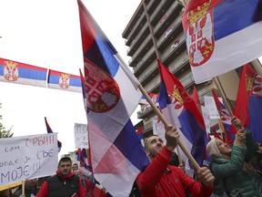 Kosovo Serbs wave Serbian flags during a protest in Mitrovica, Kosovo, Sunday, Nov. 6, 2022. Several thousand ethnic Serbs on Sunday rallied in Kosovo after a dispute over vehicle license plates triggered a Serb walkout from their jobs in Kosovo's institutions and heightened ongoing tensions stemming from a 1990s' conflict.