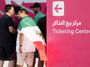 Mexico fans stand near a ticketing center for the upcoming Qatar 2022 FIFA World Cup in Doha, Saturday, Nov. 19, 2022.