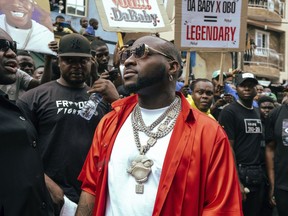 Nigeria's Afrobeats star Davido, center, attends a music video shoot in Lagos Nigeria, May 17, 2022. The 3-year-old son of Nigerian music star Davido, whose real name is David Adeleke, has died at his home in an apparent drowning, police said Tuesday, Nov. 1, 2022. Adeleke, was not at the home at the time of Ifeanyi's death Monday night. The child's mother, Chioma Rowland, was also away, according to Lagos police spokesman Ben Hundeyin.