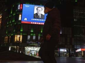 A photo of late Chinese President Jiang Zemin is seen on a big screen during the evening news broadcast of his death at a mall in Beijing, Wednesday, Nov. 30, 2022. Jiang Zemin, who led China out of isolation after the army crushed the Tiananmen Square pro-democracy protests in 1989 and supported economic reforms that led to a decade of explosive growth, died Wednesday. He was 96.