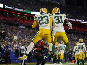 Green Bay Packers cornerback Jaire Alexander (23) celebrates with safety Adrian Amos (31) after intercepting a ball during the second half of an NFL football game against the Buffalo Bills Sunday, Oct. 30, 2022, in Orchard Park.