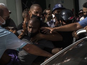 FILE - Police detain an anti-government demonstrator during a protest in Havana, Cuba, July 11, 2021. Activist groups and U.S. officials say at least six parents of Cubans serving harsh prison sentences after they participated in the July 2021 protests were temporarily detained Wednesday, Nov. 17, 2022, and prevented from visiting an American delegation.
