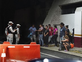 FILE - Venezuelan migrants are stopped by the National Guard at an army checkpoint on the road to Tonala, Chiapas state, Mexico, Wednesday, Oct. 5, 2022. Mexican security and immigration authorities have on Nov. stepped up patrols, highway checkpoints and raids in southern Mexico since the United States started expelling Venezuelan migrants last month.
