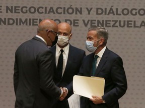 FILE - Venezuelan President of the National Assembly Jorge Rodriguez, left, shakes hands with Venezuelan opposition delegate Gerardo Blyde Perez in Mexico City, Aug. 13, 2021. The government of Venezuelan President Nicolás Maduro and representatives of the Venezuelan opposition, headed by Juan Guaidó, will resume talks that were suspended in Oct. 2021 in Mexico, according to Norwegian diplomats, announced on Nov. 24, 2022.