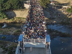 FILE - Haitians wait to cross the border between Dominican Republic and Haiti in Dajabon, Dominican Republic, Friday, Nov. 19, 2021. The Dominican Republic said on Sunday, Nov. 21, 2022 that it "profusely rejects" the denunciation of its migratory crackdowns on Haitian migrants by a growing number of countries and human rights agencies.
