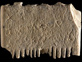 This undated image released by the Israel Antiquities Authority on Wednesday, Nov. 9, 2022, shows an ivory comb with an entire sentence in the Canaanite language, a 3,700-year-old inscription encouraging people to rid themselves of lice believed to be dated back as far as 1700 BC that was discovered in Tel Lachish, Israel. Israeli researchers say the discovery shines new light on some of humanity's earliest use of an alphabet and its ability to write.