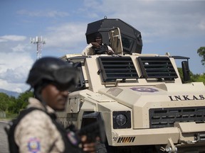 Police officers in an armored vehicle patrol the Varreux fuel terminal in Port-au-Prince, Haiti, Monday, Nov. 7, 2022. Authorities seemed to have gained control of the key fuel terminal a day after a powerful gang leader announced that he was lifting a blockade that has strangled Haiti's capital for nearly two months.