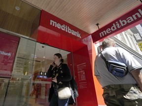 People walk past a Medibank branch in Sydney, Friday, Nov. 11, 2022. Extortionists have dumped personal medical records on the dark web for a third day as they pressure Australia's largest health insurer to pay a ransom for the stolen customer data of almost 10 million people.