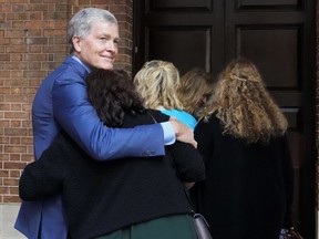 FILE - Steve Johnson, brother of U.S. murder victim Scott Johnson, hugs his wife Rosemarie as they arrive at the Supreme Court in Sydney, May 2, 2022, for a sentencing hearing in the murder of Scott. A government inquiry began hearing evidence on Wednesday, Nov. 2, 2022, of unsolved deaths resulting from gay hate crime over four decades in New South Wales, Australia's most populous state, where police were notoriously indifferent to such violence.