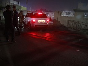 Iraqi security forces gather outside a morgue of Sheikh Zayed Hospital in Baghdad, Monday, Nov. 7, 2022. Assailants shot dead an American aid worker in Baghdad on Monday in a rare killing of a foreigner in the Iraqi capital in recent years, two police officials said.