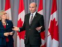 Health Minister Jean-Yves Duclos, right, responds to a question following a cabinet meeting in Ottawa in 2021.