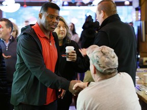Georgia Republican Senate nominee Herschel Walker greets patrons during a campaign stop at Marietta Diner in Marietta, Georgia, on Dec. 6, 2022.