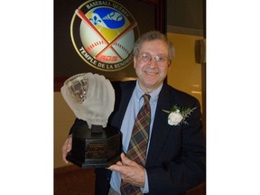 Richard Milo holds his trophy for being inducted into the Quebec Baseball Hall of Fame in Montreal Thursday May 31, 2007. Milo, a longtime Canadian Press writer, has been named the winner of the Canadian Baseball Hall of Fame and Museum's 2022 Jack Graney Award.