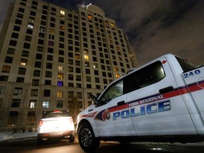 Police vehicles parked in the driveway after a fatal mass shooting at a condominium building in the Toronto suburb of Vaughan, Ontario, Canada December 19, 2022.