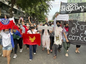 Pro-democracy protesters hold a flash mob rally to protest against Myanmar's military-installed government, at Kyauktada township in Yangon, Myanmar Monday, Dec. 20, 2021.&nbsp;Canada is sanctioning dozens of officials and companies from three of the world's worst regimes for human rights.Ottawa will freeze any Canadian assets held by 67 people and nine entities in Russia, Iran and Myanmar. THE CANADIAN PRESS/AP