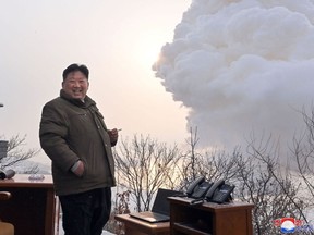 This picture taken on December 15, 2022 and released from North Korea's official Korean Central News Agency (KCNA) on December 16, 2022 shows North Korea's leader Kim Jong Un as he directs a ground ejection test - a high-power solid fuel engine test - conducted at the Saikai satellite launch site in South Pyongan Province.