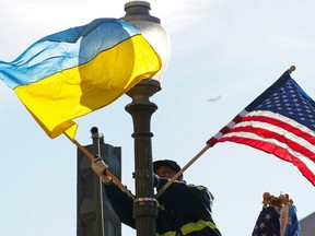 A worker installs Ukrainian and U.S. flags along Pennsylvania Avenue leading to the U.S. Capitol ahead of a visit by Ukraine's President Volodymyr Zelenskiy for talks with U.S. President Joe Biden and an address to a joint meeting of Congress in Washington, U.S., December 21, 2022.
