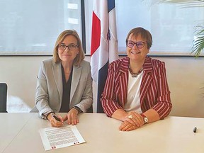 Ambassadors Christine Laberge of Canada, left, and Rita Hämmerli-Weschke of Switzerland sign a news release urging the Dominican Republic president to let a proposed Canadian gold mine undergo environmental assessment, after seven years of delay.
