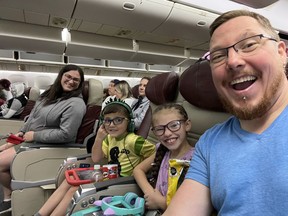 Danielle Cody and Jesse Cody with their two children on their flight back to Canada.