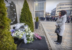 Former Quebec Liberal leader Dominique Anglade pauses for a moment after placing white roses at the Dec. 6 commemorative plaque during a ceremony at the École Polytechnique in Montreal