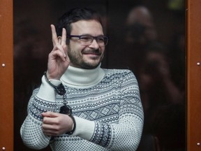 Russian opposition leader, former Moscow's municipal deputy Ilya Yashin gestures in a defendants' glass cage prior to a verdict hearing at the Meshchansky district court in Moscow, Russia, December 9, 2022. Prosecution requested nine years in prison for Yashin for spreading fake information about the Russian army.