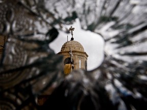 A church dome is seen through the broken window of a convent that was damaged by artillery fire in Sednaya, north of Damascus, Syria, in a file photo from 2012.