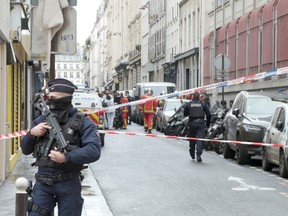 Members of emergency services work at the site where gunshots were fired in central Paris, France, December 23, 2022, in this still image obtained form a social media video.
