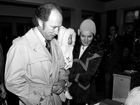 Then-prime minister Pierre Trudeau, left, and his wife Margaret, right, carry future prime minister Justin Trudeau in 1972.