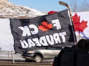 A "f--k Trudeau" flag is seen as a convoy of cars and trucks leaves Devon, Alta., to travel to the Alberta Legislature in Edmonton in support of the national Freedom Convoy, on Jan. 29, 2022.